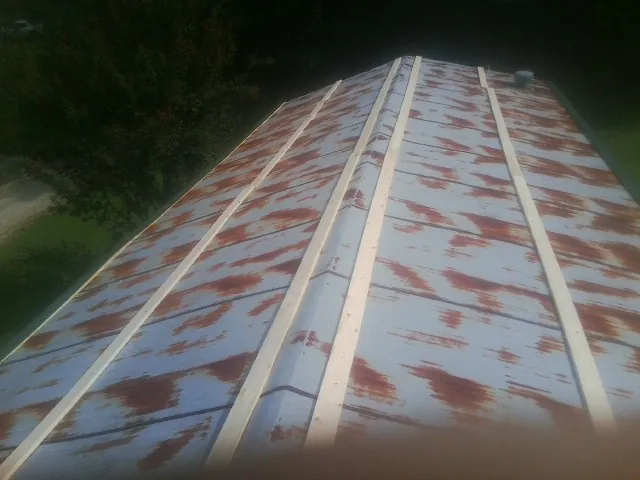 Rusted metal roof panels with new wood purlins before replacement — Storm Damage Roof Repair in Foss by Roofing Brothers
